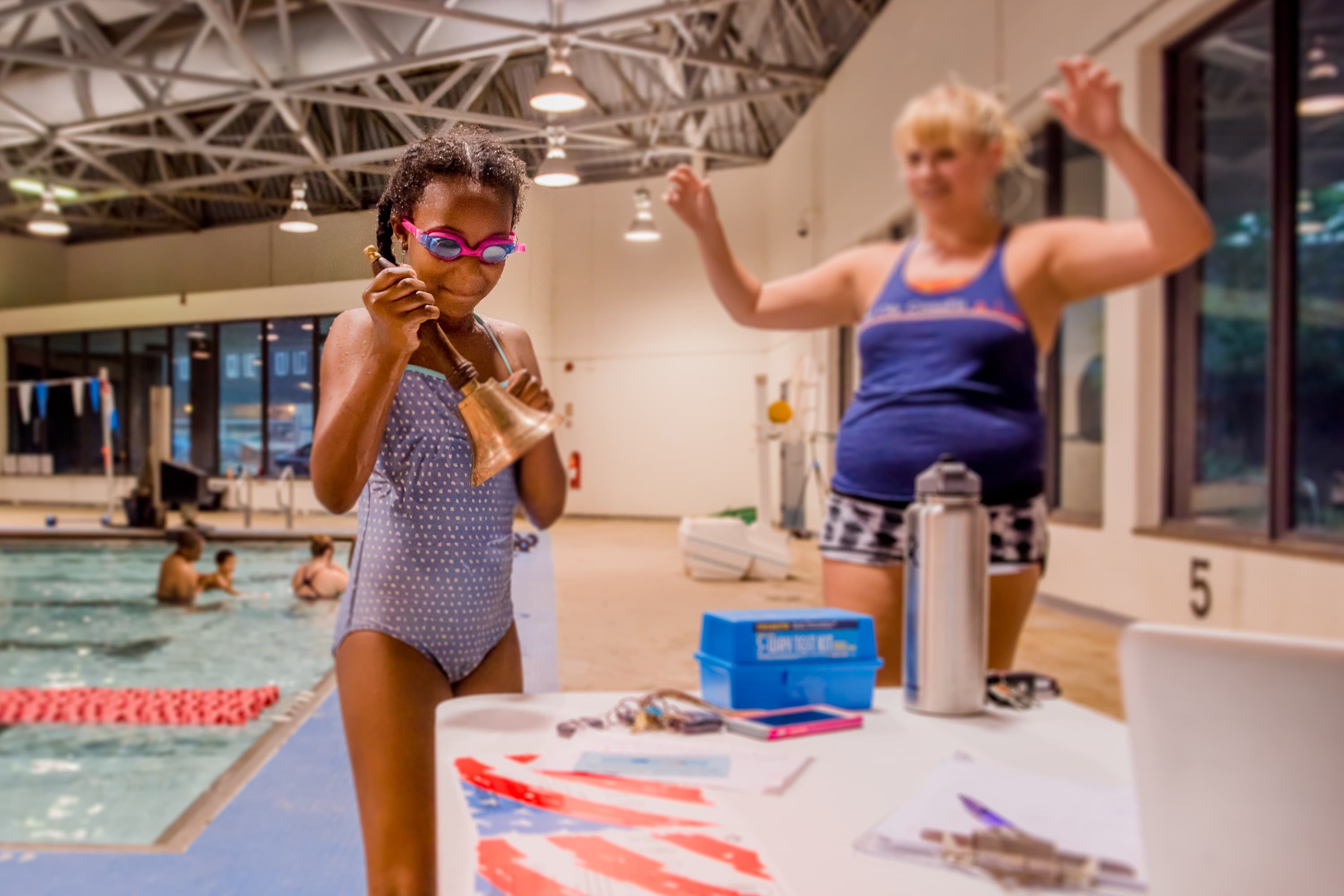 Meg Emery celebrating with swimmers at Old City Swim School