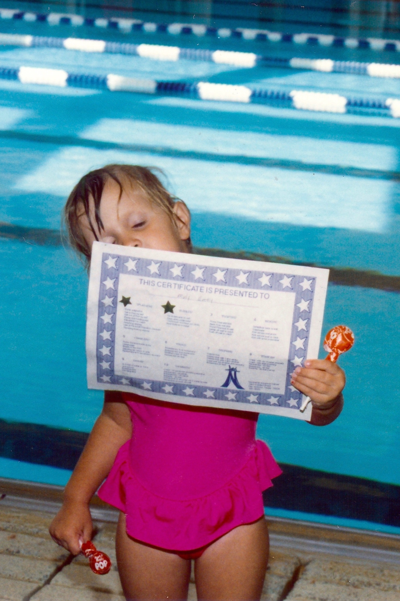 Molly Emery holding her swim level certificate — San Antonio, 1996