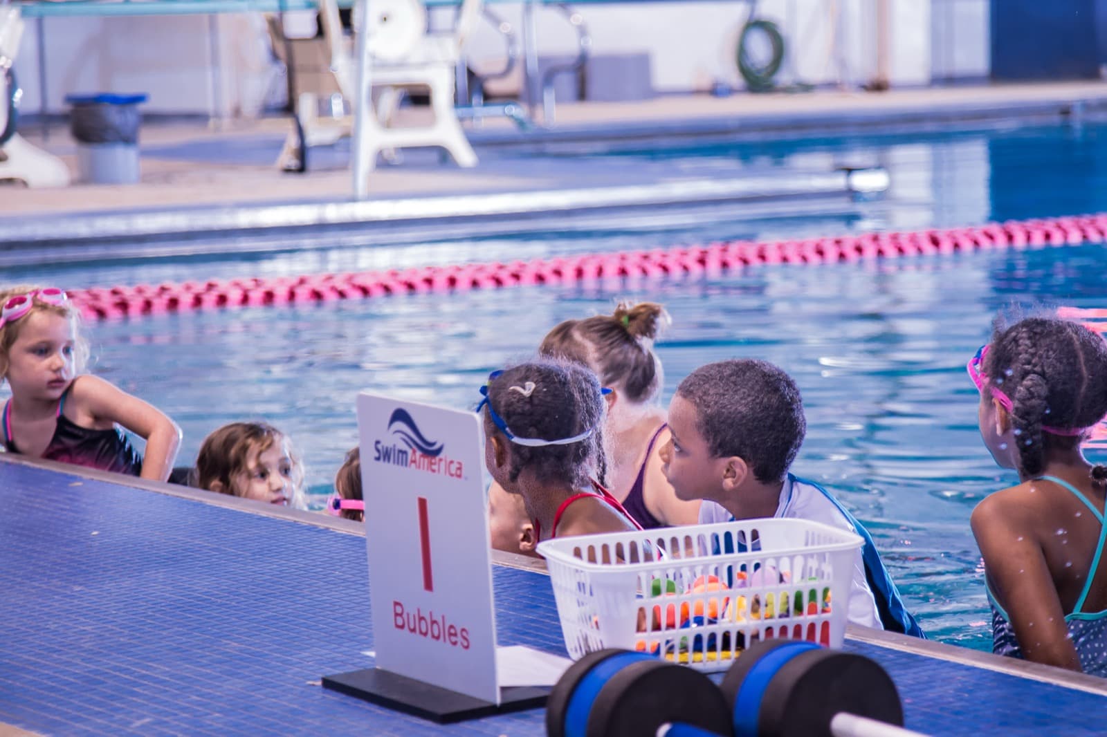 OCSS coaches high-fiving swimmers on the pool deck